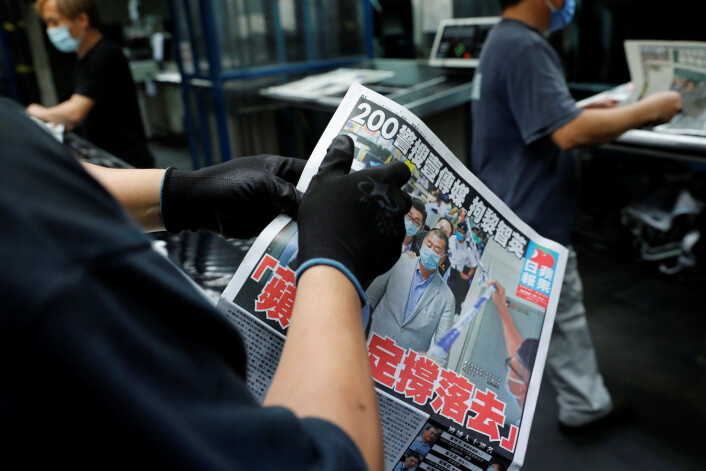Apple Daily slo i dag opp at avisens eier er arrestert. Bildet viser Jimmy Lai i redaksjonslokalene sammen med politifolkene. Apple Daily slo i dag opp at avisens eier er arrestert. Bildet viser Jimmy Lai i redaksjonslokalene sammen med politifolkene.